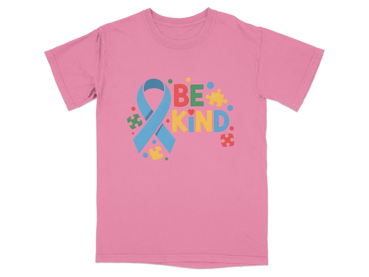Pink t-shirt with "BE KIND" text and autism awareness ribbon surrounded by puzzle pieces.
