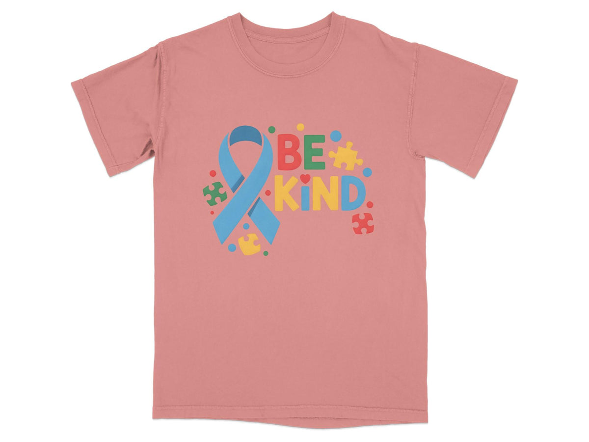 Pink t-shirt with "BE KIND" text and autism awareness ribbon and puzzle pieces.