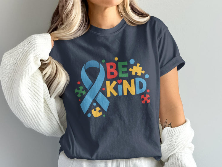 Dark blue t-shirt with "BE KIND" text and autism awareness ribbon and puzzle pieces.