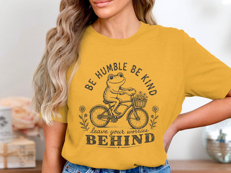 Yellow t-shirt with frog riding a bicycle, "BE HUMBLE BE KIND" and "leave your worries BEHIND".