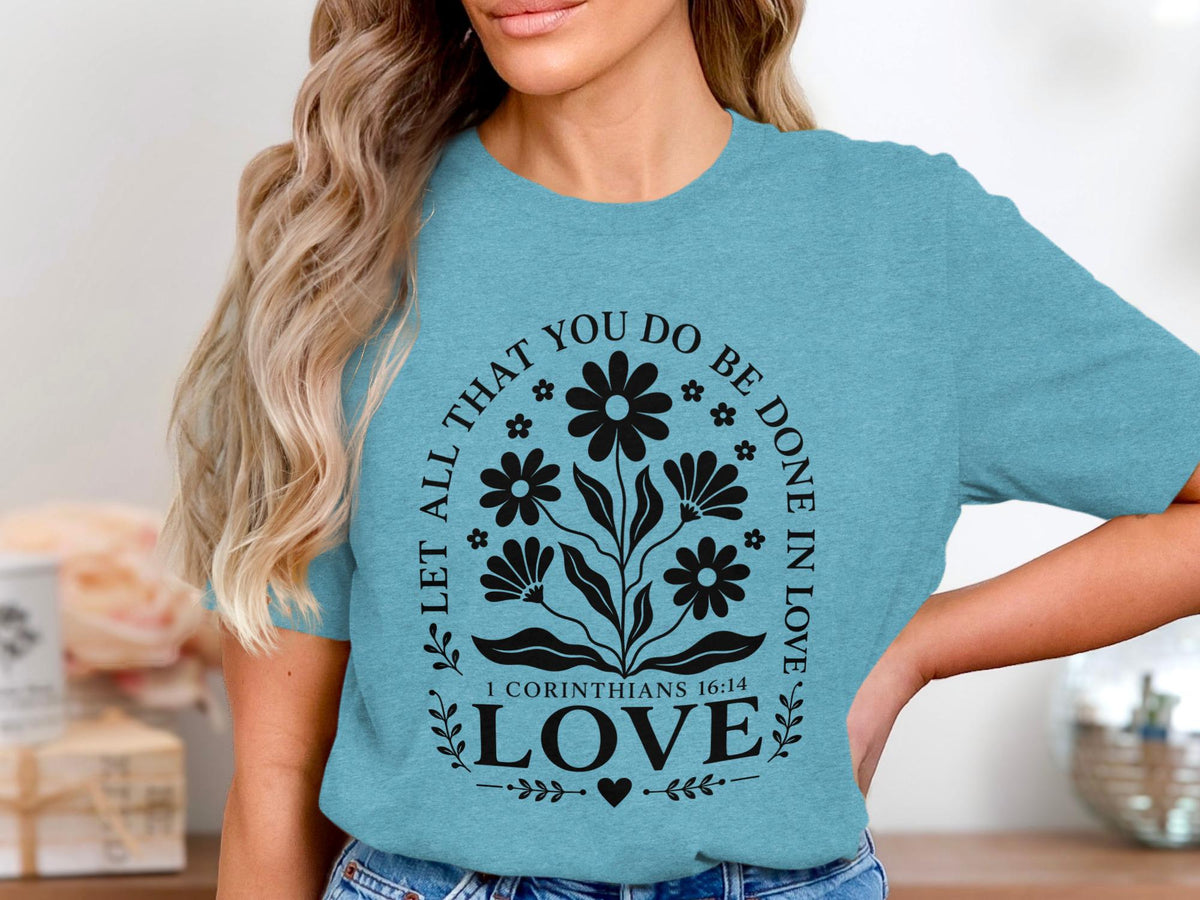 Teal t-shirt with floral design and text "Let All That You Do Be Done in Love".