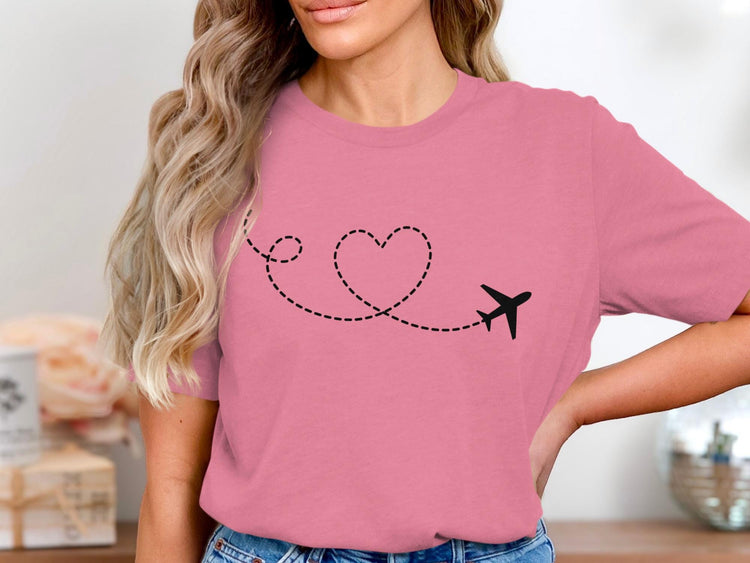 Pink t-shirt with a black airplane and dotted heart line design.