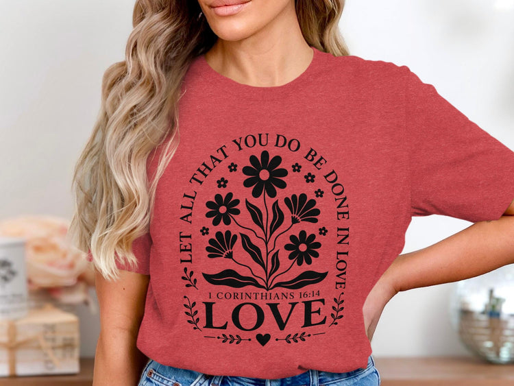Red t-shirt with floral design and "Love 1 Corinthians 16:14" text.