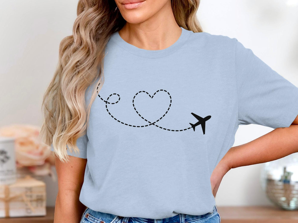 Light blue t-shirt with black airplane and dotted heart trail graphic.