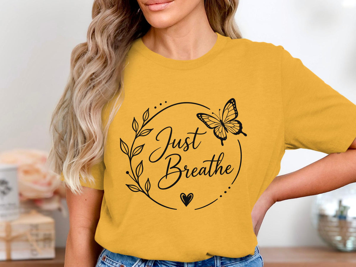 Yellow t-shirt with "Just Breathe" graphic and butterfly design.