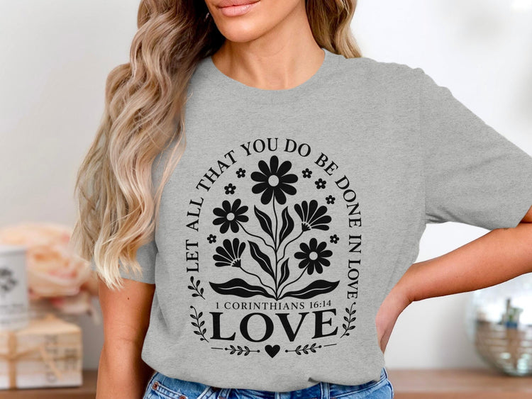 Grey t-shirt with floral design and text "Let all that you do be done in love 1 Corinthians 16:14 LOVE".
