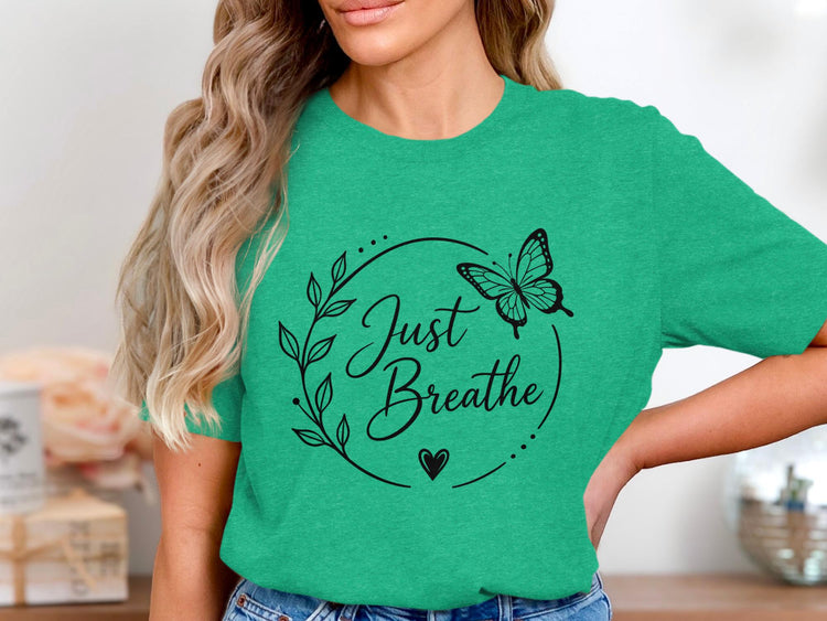 Green t-shirt with "Just Breathe" text, butterfly, leaves, and heart design.