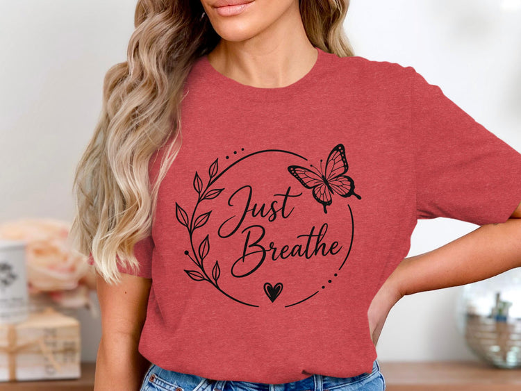 Red t-shirt with black floral wreath, butterfly, heart, and "Just Breathe" text.