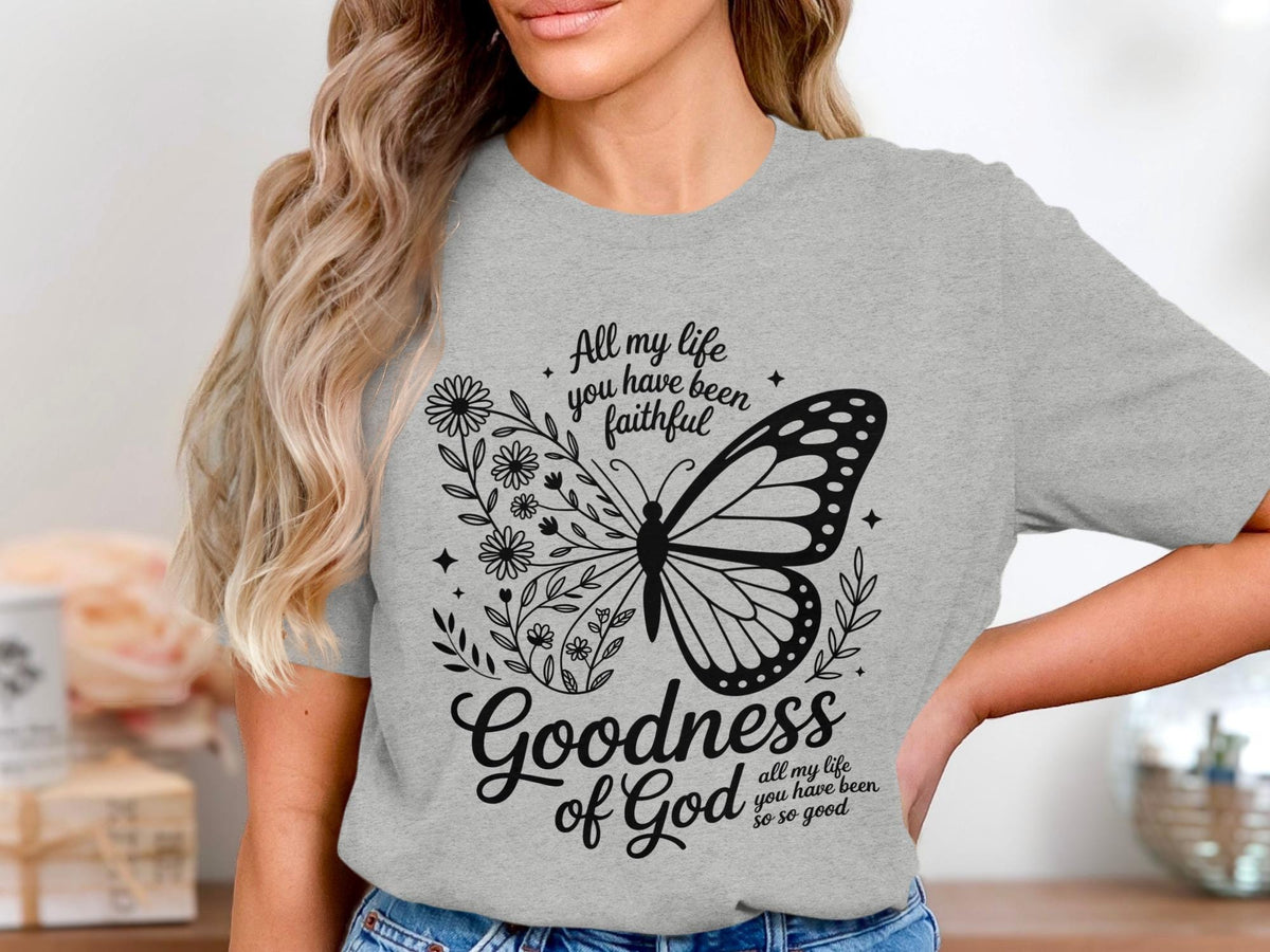 Grey t-shirt with butterfly, flowers, and "Goodness of God all my life you have been faithful so so good" text.