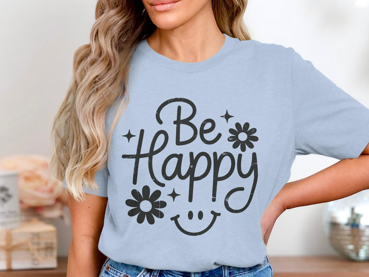 Light blue t-shirt with black graphic text that says "Be Happy" with flowers.