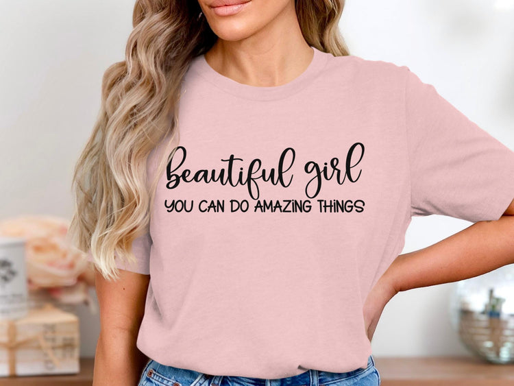 Pink t-shirt with black text: "beautiful girl YOU CAN DO AMAZING THINGS".