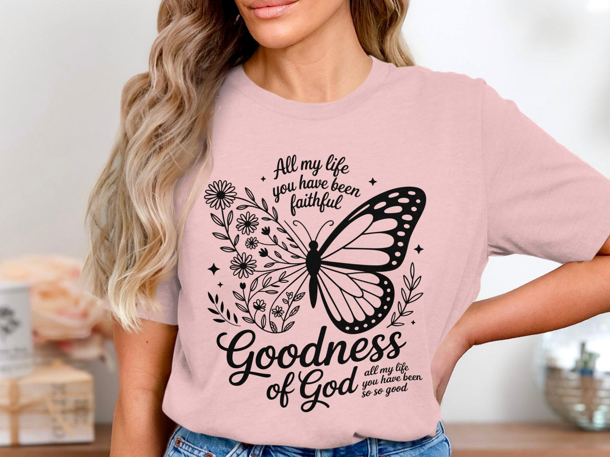 Pink t-shirt with butterfly and floral design, text reads "Goodness of God all my life you have been so so good".