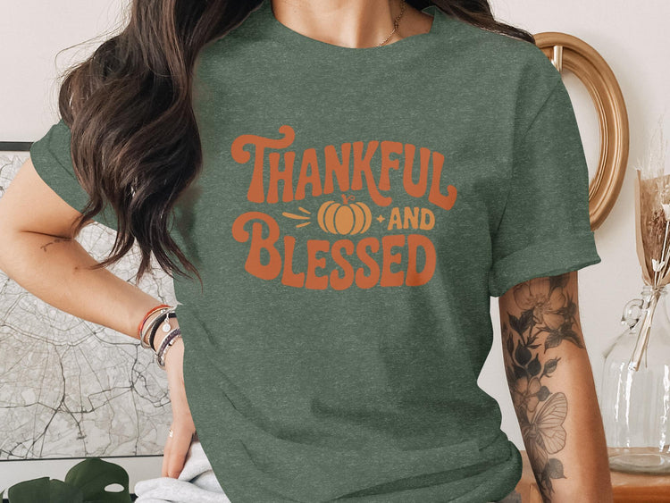 Green t-shirt with orange text "Thankful and Blessed" and a pumpkin graphic.