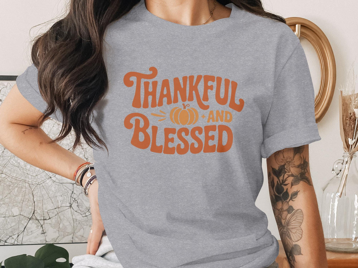 Grey t-shirt with orange text reading "Thankful AND Blessed" with a pumpkin.