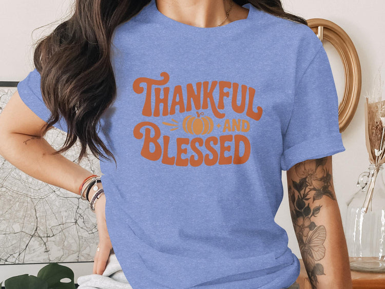 Periwinkle t-shirt with orange text that says "Thankful and Blessed" with a pumpkin graphic.
