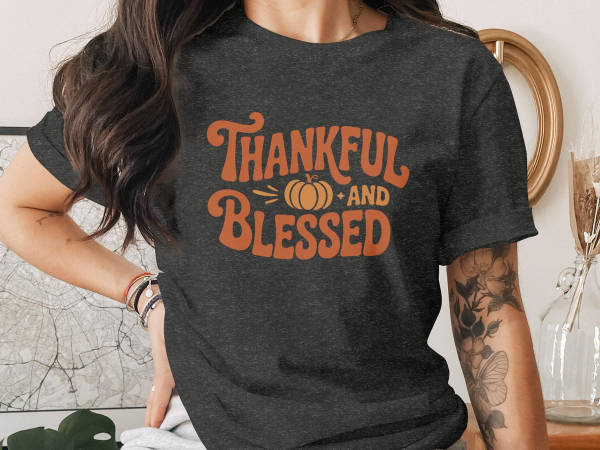 Dark grey t-shirt with orange text "Thankful AND Blessed" and a pumpkin graphic.