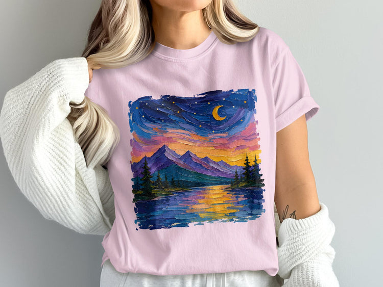 Pink t-shirt with a textured oil painting of a moonlit mountain lake and pine trees.