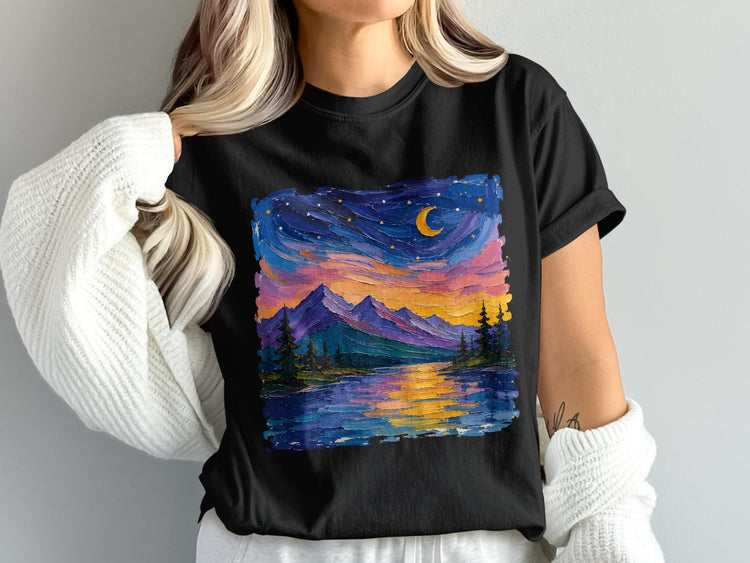 Black t-shirt with a colorful starry night landscape painting of mountains and a lake.