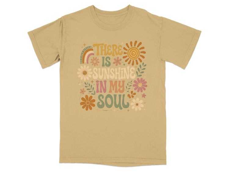 Tan t-shirt with "There Is Sunshine In My Soul" graphic and retro flowers.