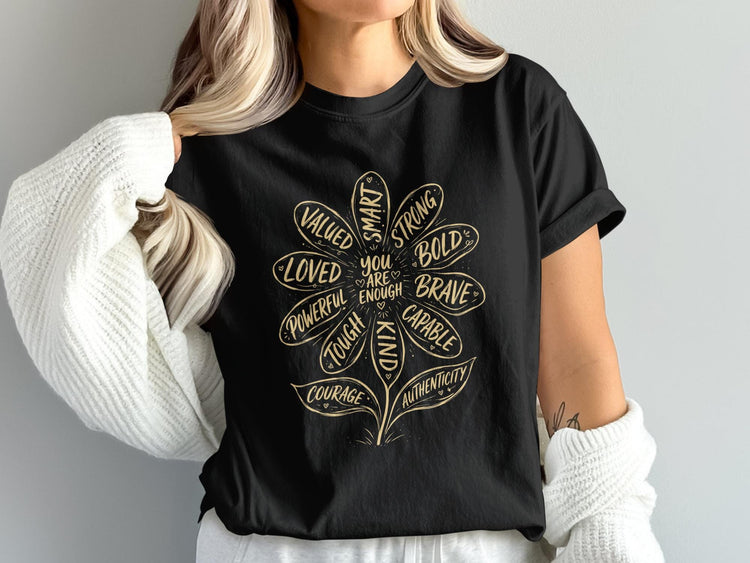 Black t-shirt with a flower illustration listing positive attributes and "You are enough."
