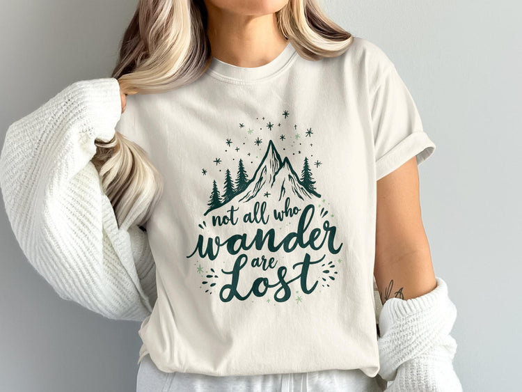 Cream t-shirt with mountain graphic and text "not all who wander are lost."
