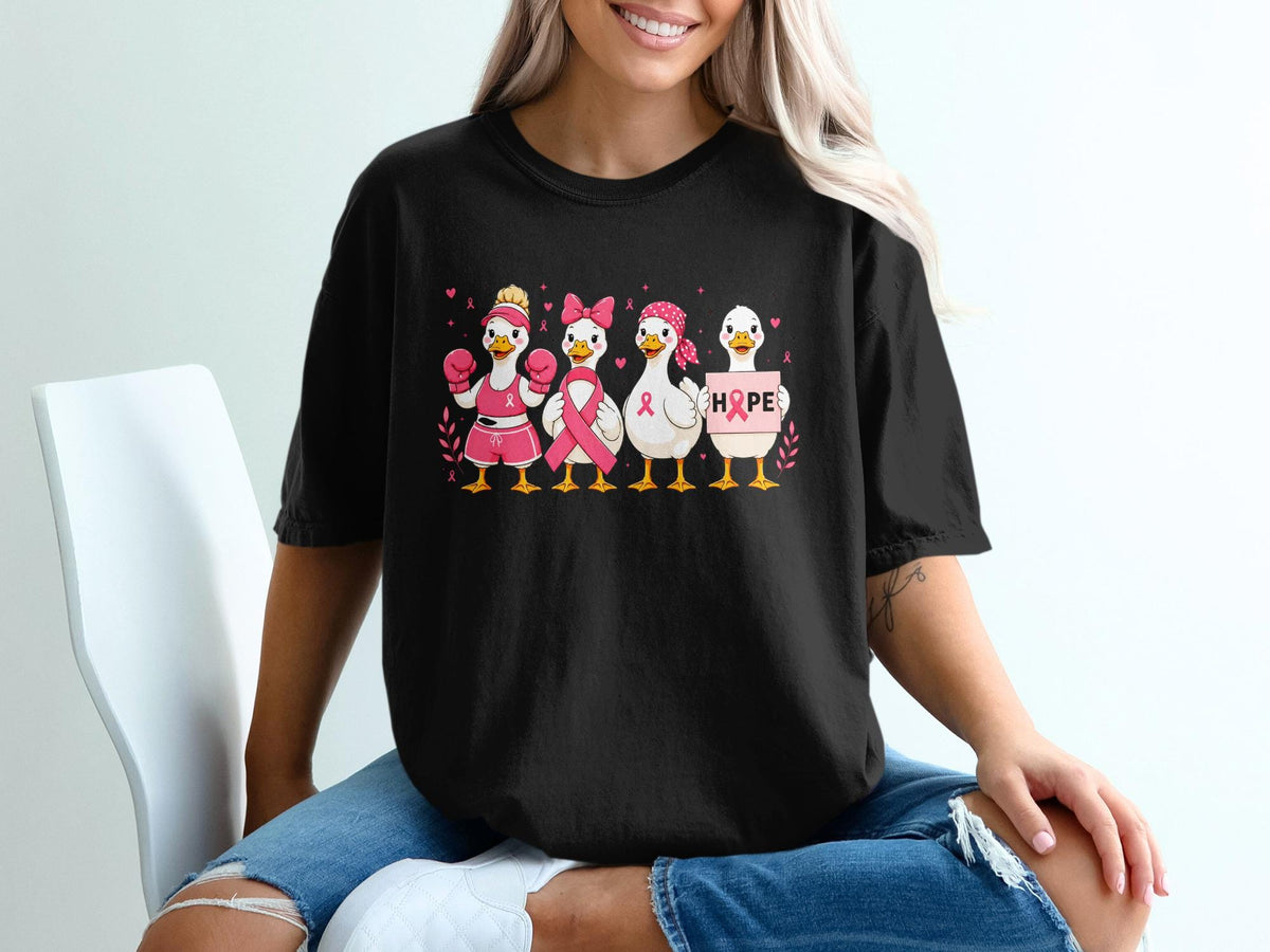 Four ducks in pink outfits with breast cancer awareness ribbons and a sign that says HOPE.