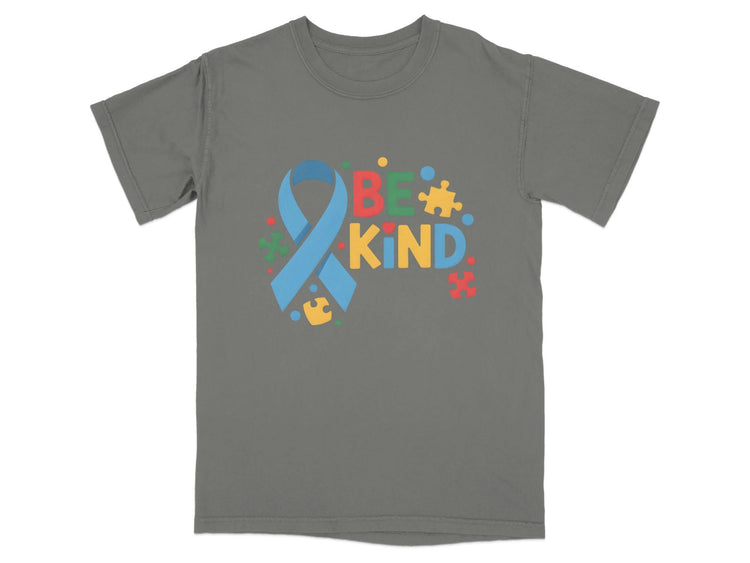 Grey t-shirt with the text "BE KIND" and autism awareness ribbon and puzzle pieces.