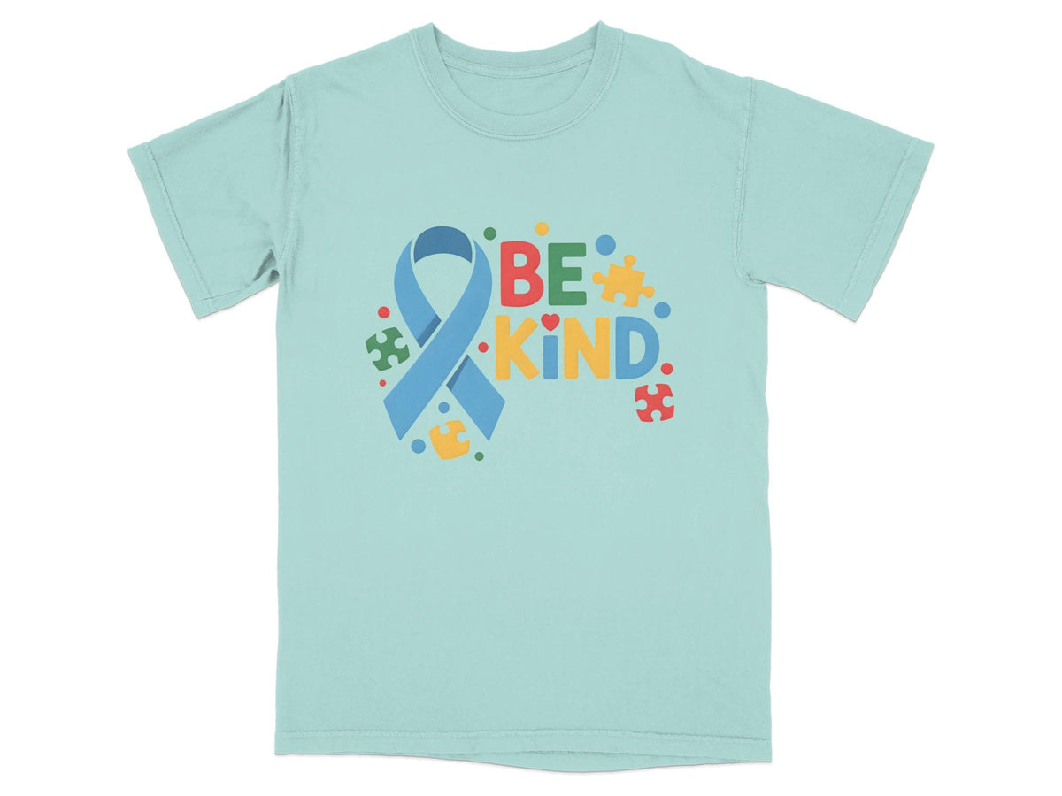 Light blue t-shirt with "BE KIND" text and autism awareness ribbon design.