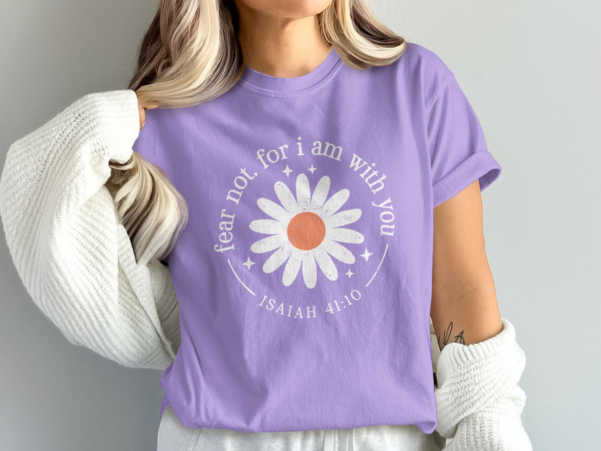 Purple t-shirt with white daisy graphic and text "fear not, for I am with you, ISAIAH 41:10".