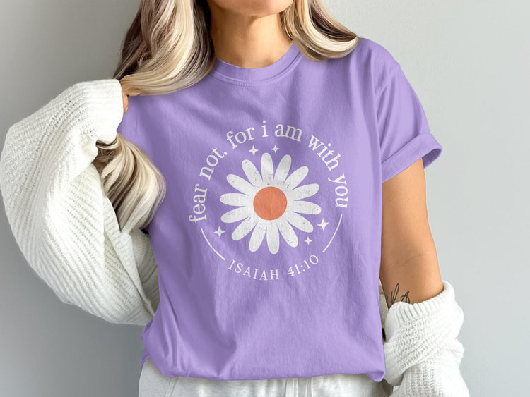 Purple t-shirt with white daisy graphic and text "fear not, for I am with you, ISAIAH 41:10".