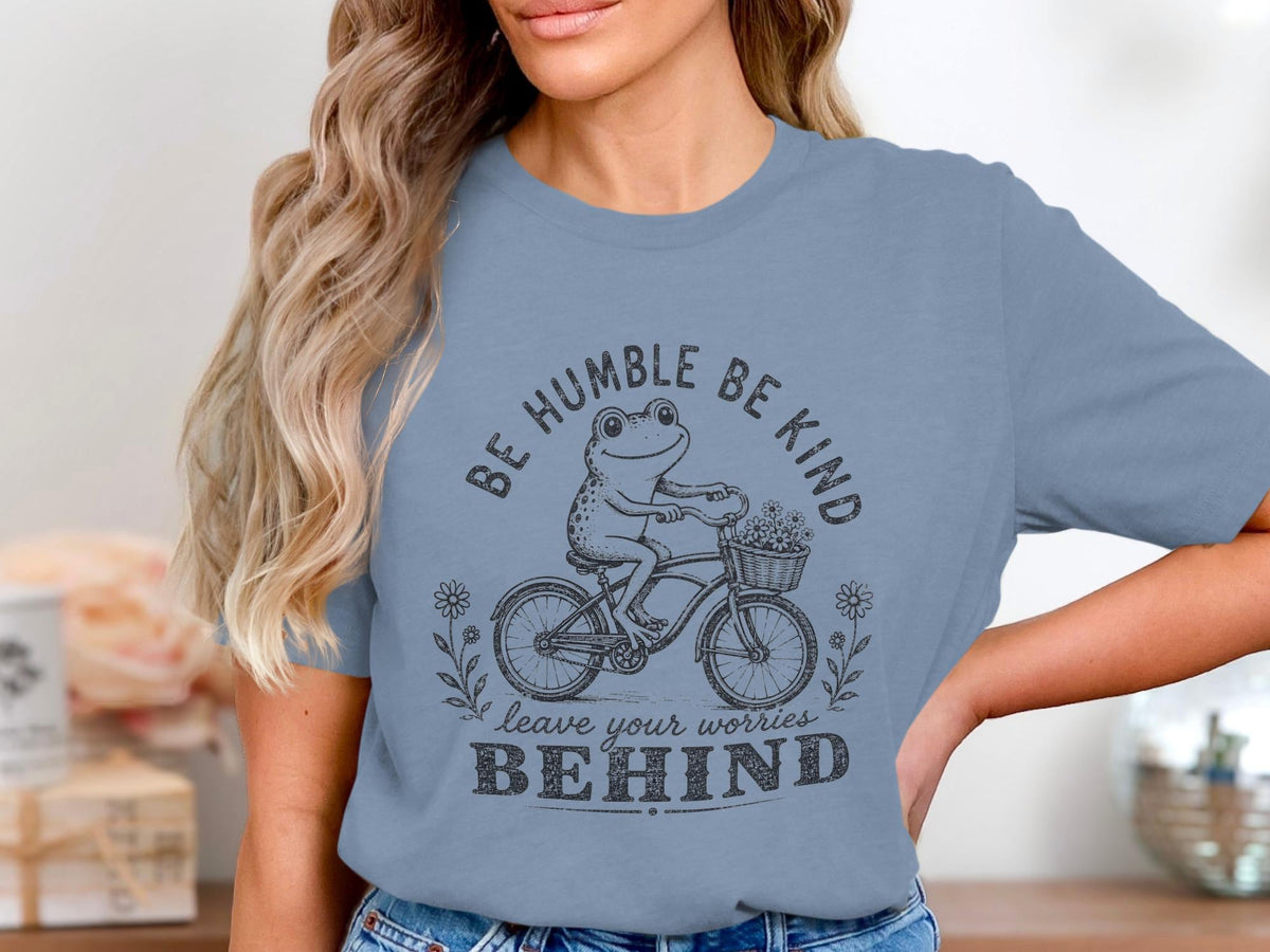 Frog cycling with flowers on front and quote "Be Humble Be Kind leave worries Behind".