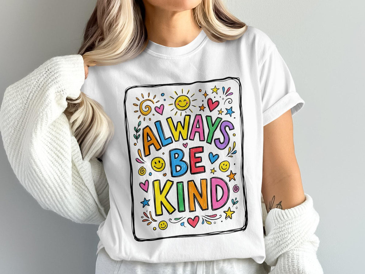 White t-shirt with "ALWAYS BE KIND" text in colorful, playful lettering and surrounding graphics.