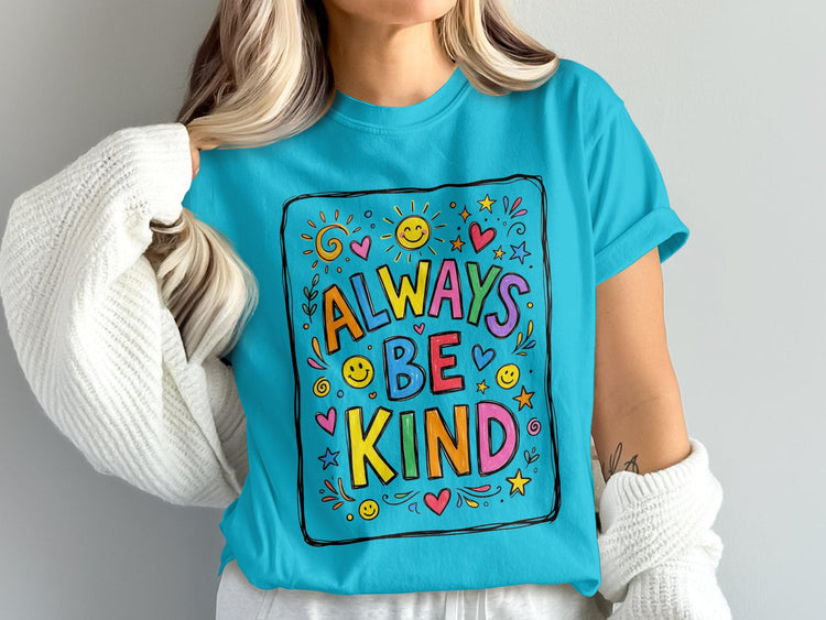 Turquoise t-shirt with "ALWAYS BE KIND" text surrounded by colorful hearts, stars, and suns.