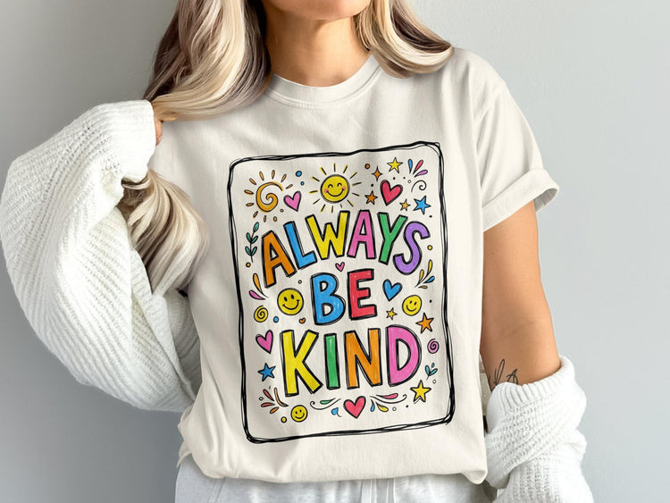 Cream t-shirt with colorful "Always Be Kind" text and cheerful illustrations.
