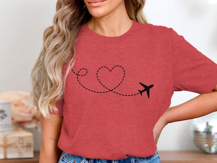 Coral t-shirt with black airplane creating a broken heart-shaped flight path.