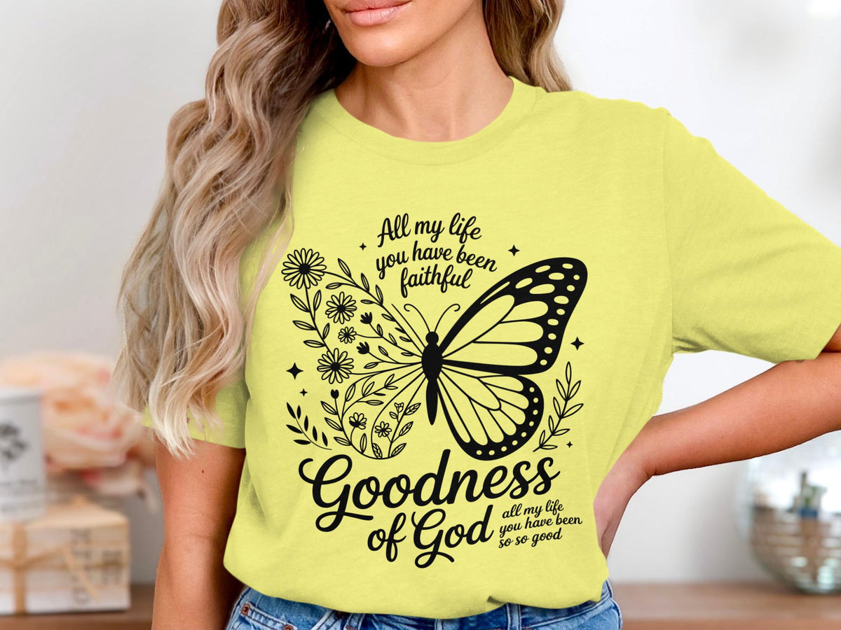 Yellow t-shirt with black butterfly, floral design, and text "Goodness of God".