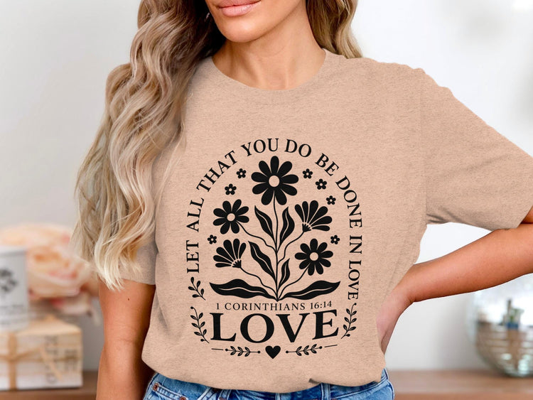 Peach t-shirt with floral graphic and text "Let all that you do be done in love."