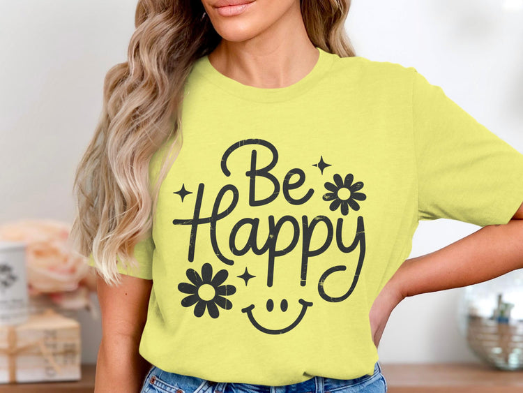 Yellow t-shirt with black text "Be Happy" and floral accents.