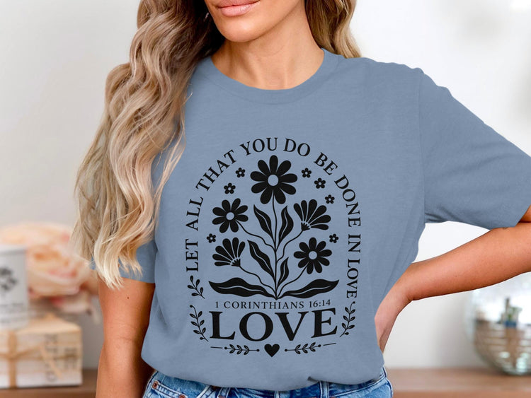 Blue t-shirt with black floral design and text "Let all that you do be done in love"