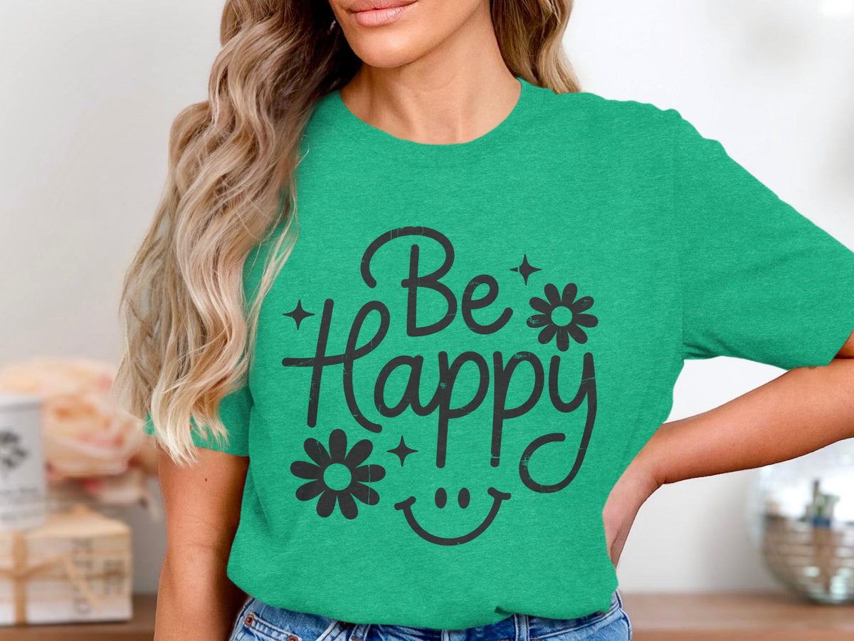 Green t-shirt with black text reading "Be Happy" and a smiley face graphic.