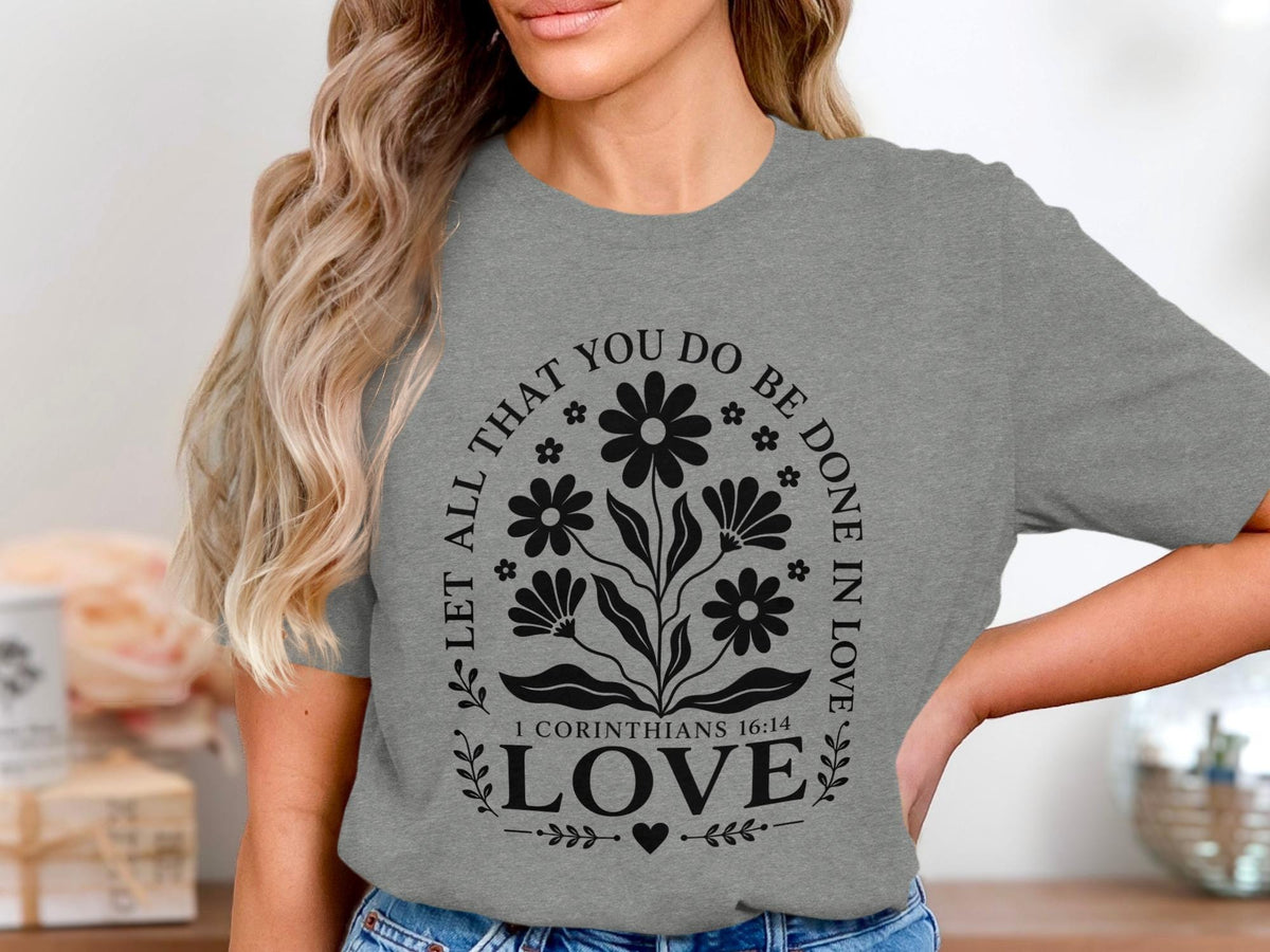 Grey t-shirt with floral design and "Let All That You Do Be Done In Love."