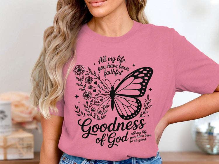 Pink t-shirt with butterfly and floral design, featuring text "Goodness of God".