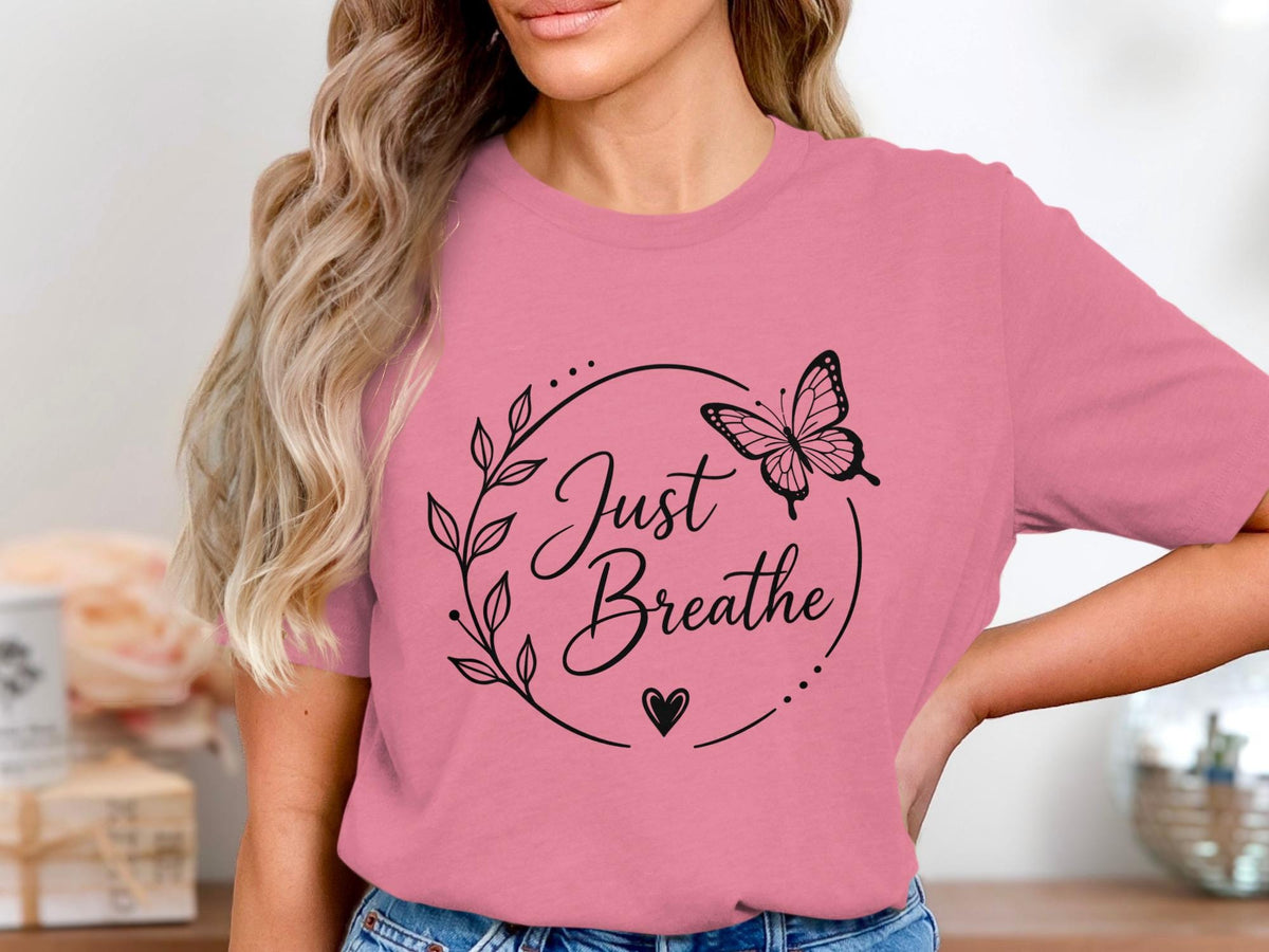 Pink t-shirt with black "Just Breathe" text design and butterfly.