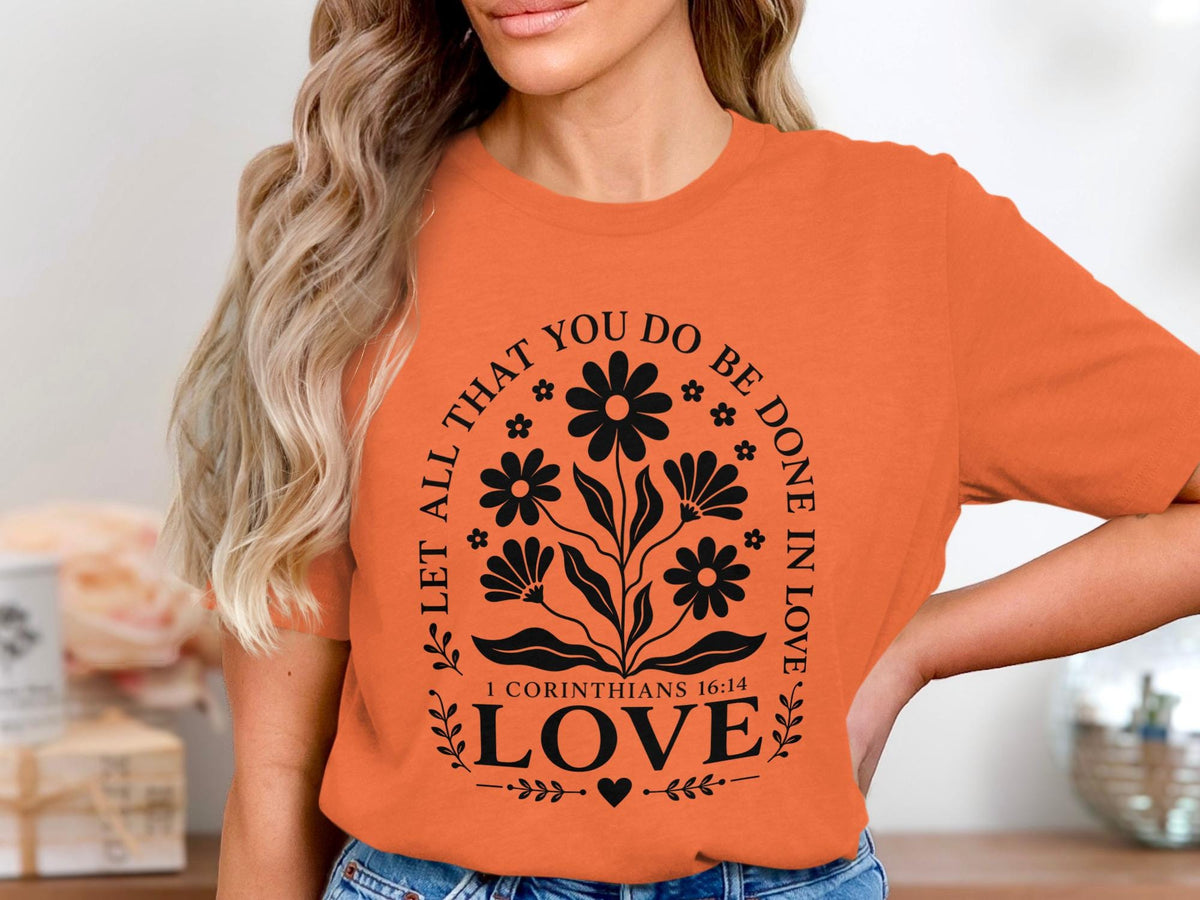 Orange t-shirt with black floral design and "Love" text.