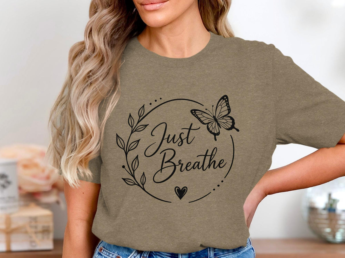 T-shirt with black "Just Breathe" text, a butterfly, heart, and leafy wreath design.
