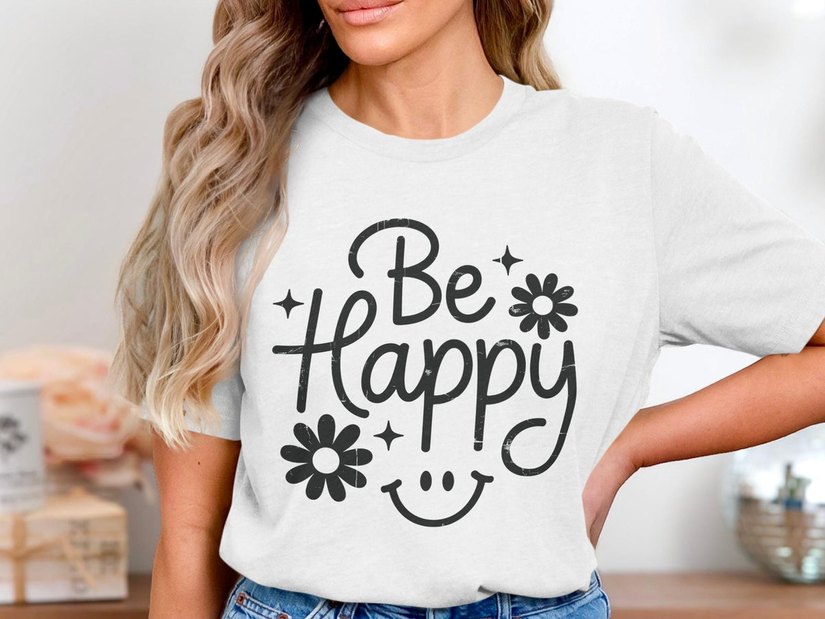 White t-shirt with "Be Happy" text, flowers, and smiley face graphic.
