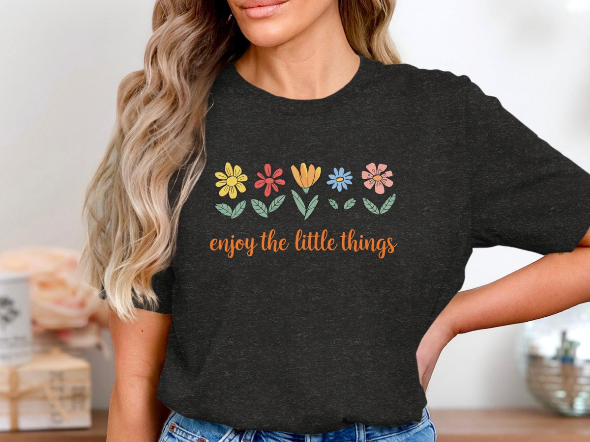 Dark t-shirt with colorful flowers and text "enjoy the little things".