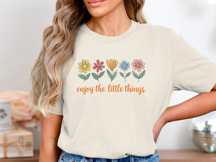 Light cream t-shirt with colorful floral graphic and "enjoy the little things" text.