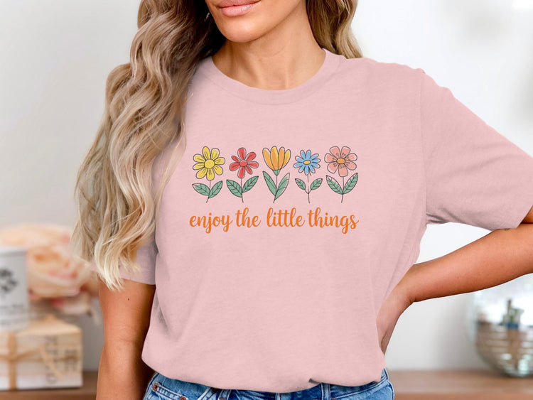 Pink t-shirt with colorful flowers and text "enjoy the little things".
