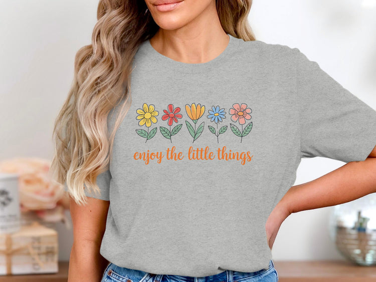 Grey t-shirt with colorful flowers and "enjoy the little things" text.